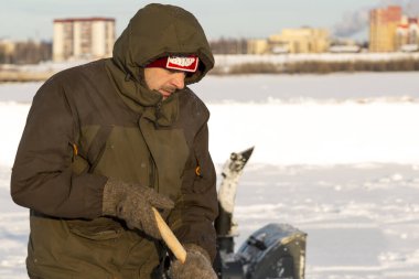 Elinde kürekle bir işçinin portresi.