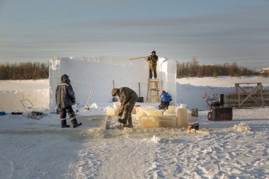 Fitter with steel tongs pulls out ice block