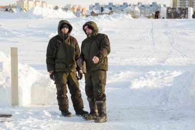 Builders on the ice of a frozen river