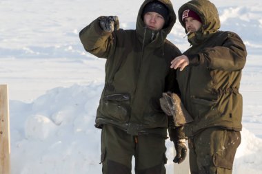 Builders on the ice of a frozen river