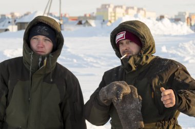 Builders on the ice of a frozen river