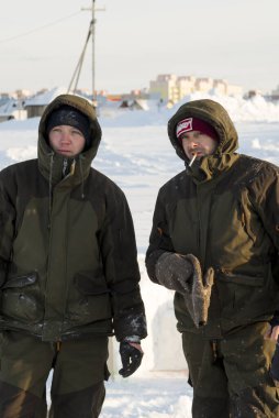 Builders on the ice of a frozen river