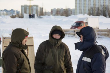 Builders on the ice of a frozen river