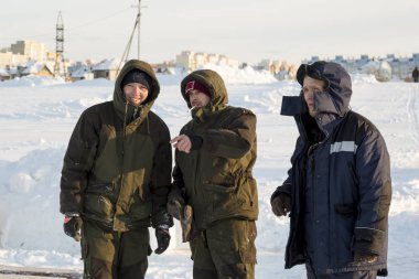 Builders on the ice of a frozen river