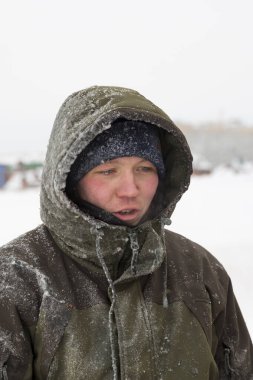 Worker's face close up in january day