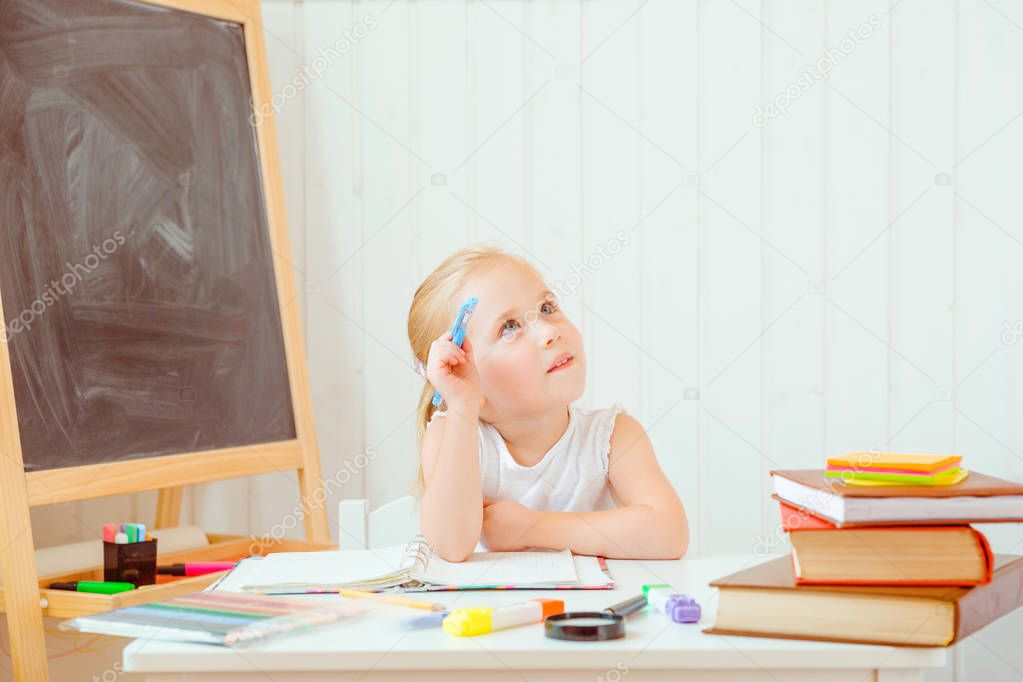 Childhood and back to school concept. Girl with thoughtful face expression does homework