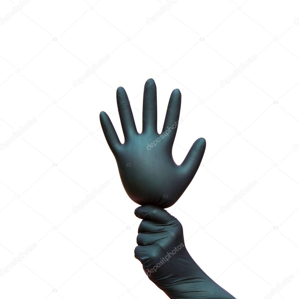 a hand in a black surgical glove holds the inflated glove like a balloon. Isolated on a white background. The symbol of the celebration of the victory over coronaviruses.