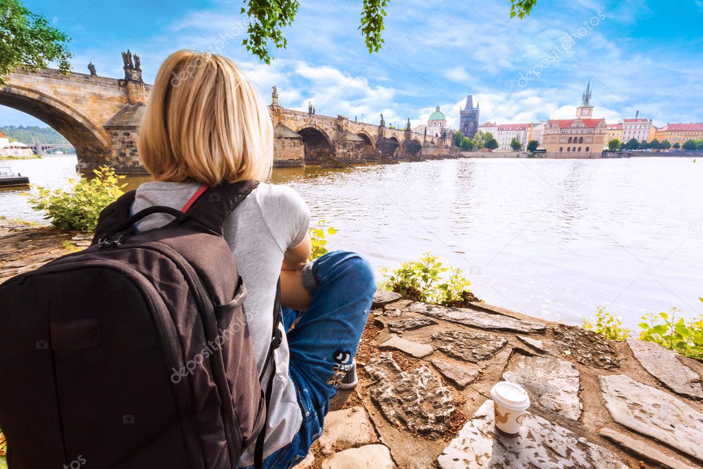 Female traveler enjoys views of the Charles Bridge in Prague