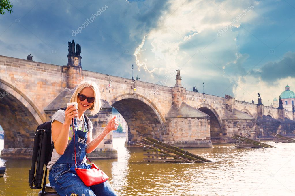 Female traveler enjoys views of the Charles Bridge in Prague