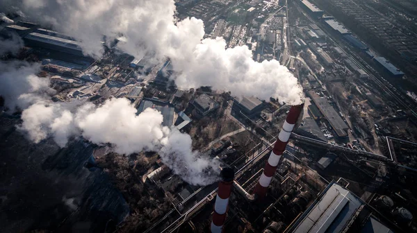 Air pollution by smoke coming out of two factory chimneys. Aerial view — Stock Photo, Image