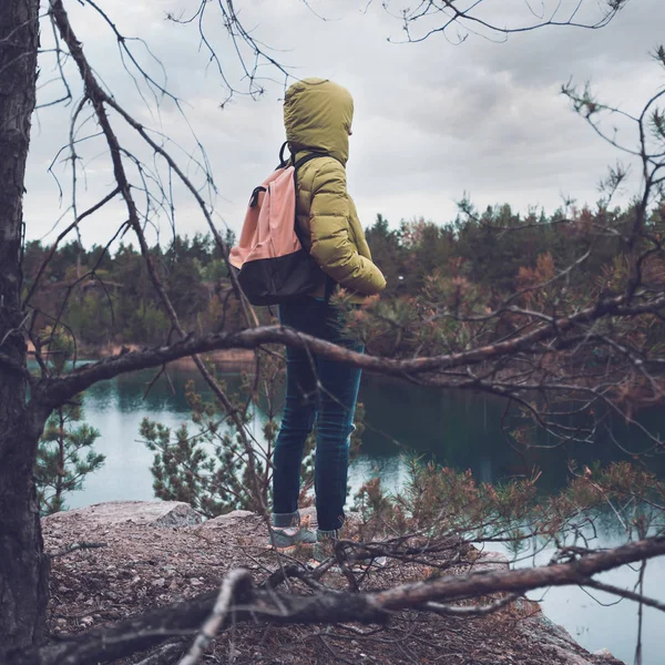 Mladá dívka s batohem se kochat výhledem na jezero. — Stock fotografie