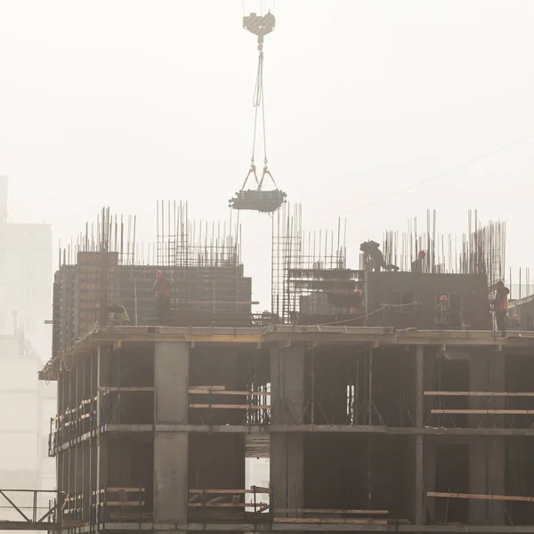 A new residential building under construction in the morning mist. — Stock Photo, Image