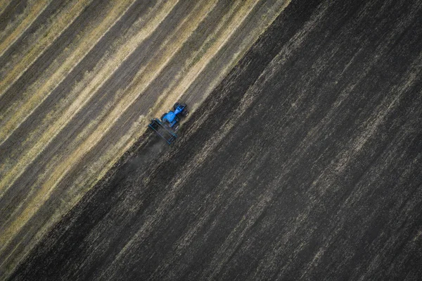 Трактор обробки поля навесні, вигляд з повітря — стокове фото