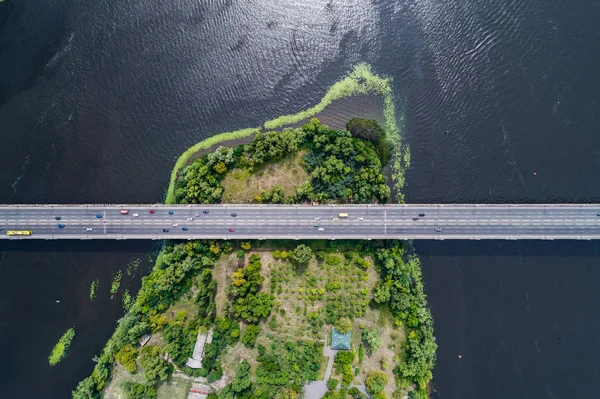 Aerial view of the bridge and the road over the Dnepr River over a green island in the middle of the river — Stock Photo, Image