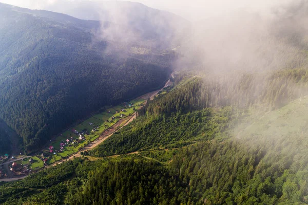 Letecký pohled na obec v Karpatských horách s mraky v popředí — Stock fotografie