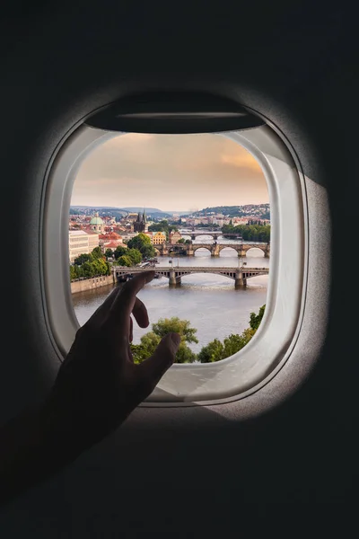 Airplane window with a aerial panorama of Prague, Czech Republic during a flight — Stock Photo, Image