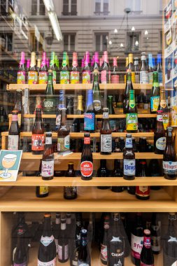 Different sorts and brands of Belgian beer in a shop window