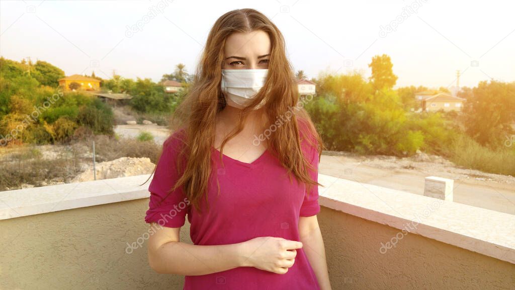 Alarmed woman in protective surgical mask. Chinese Coronavirus disease COVID-19 is dangerous and very aggressive.