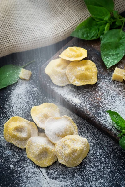 Ravioli cosparsi di farina sul tavolo di legno della cucina , — Foto Stock