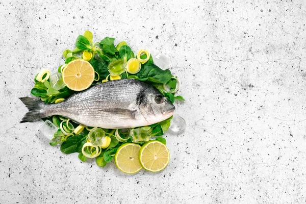 Fresh sea Bream fish on herbs and spices - preparing for cooking on white background. The concept of healthy food, top view and copy space.