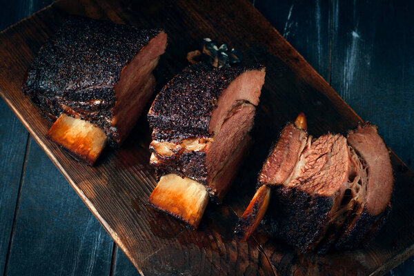 Chopping board with Smoked beef brisket ribs, Classic Texas BBQ