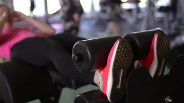 Yakın çekim kadın fitness pembe ayakkabı. Egzersiz spor salonu ya da ev, abs, güzel bacaklar atlama detayını. Spor ayakkabı içinde uzanan sporcumuz.