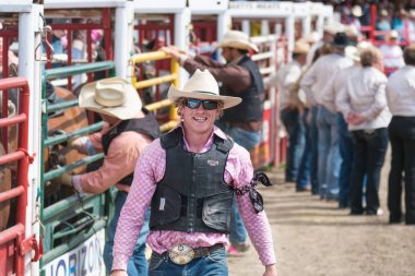 Williams Lake, British Columbia/Canada  - July 2, 2016: one of the Wild Horse Race team members smiles for photographers at the 90th Williams Lake Stampede, an internationally famous event. clipart