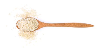 Sesame seeds on a wooden spoon as a white background.