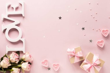 Hediye kutusu ya da hediye kutusu ve pembe masa manzaralı çiçekler. Düz yatıyordu. Doğum günü, düğün, sevgililer günü, 8 Mart konsepti. Boşluğu kopyala