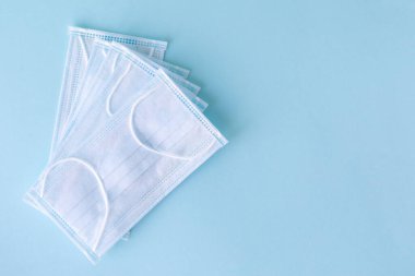 Mavi arka planda tıbbi konsept. Virüse karşı korunmak için tıbbi maske. Metin için yer