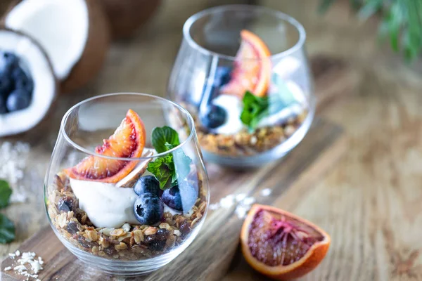 Diet dessert with yogurt, granola and fresh berries, close-up, horizontal. Healthy breakfast ingredients. copy space