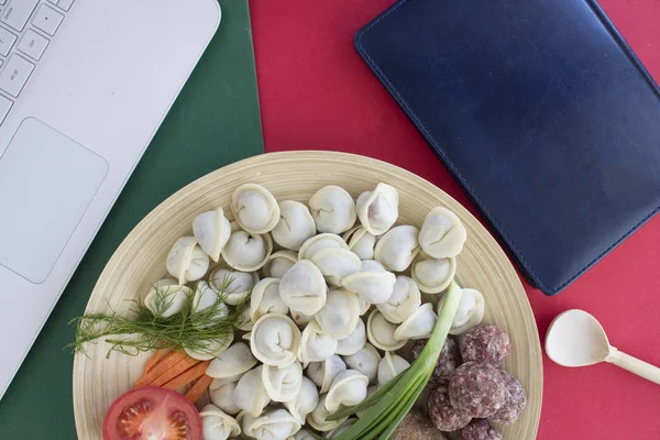 ready meal to eat pelmeni note book and laptop