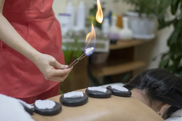 Woman setting fire to zen basalt stones. Soft focus — Stock Photo, Image