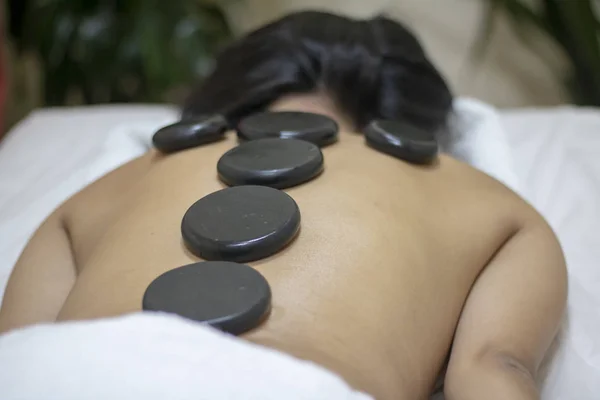 Back massage with hot stones. Horizontal photo — Stock Photo, Image