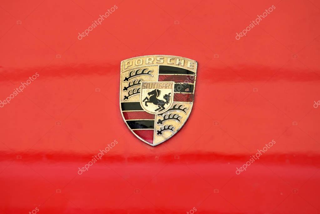 VILNIUS, LITHUANIA - APRIL 27: old and scrached Porsche sign close up on the car front on April 27, 2017 in Vilnius, Lithuania. Ferdinand Porsche founded the company in 1931 with main offices in the centre of Stuttgart
