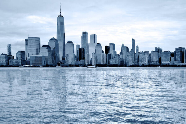 Manhattan Skyline over Hudson river, New York City, Black and white blue toned