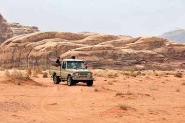 Wadi Rum Köyü, Ürdün - 19 Şubat 2020. Turistler kamyonette oturuyor ve Wadi Rum Çölü 'nde turun tadını çıkarıyorlar..