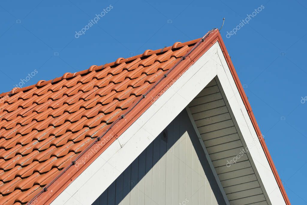 Roof of the house, red roof tile against the blue sky
