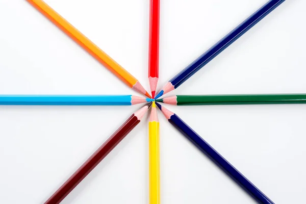 Colored pencils arranged in a star shape in natural light — Stock Photo, Image