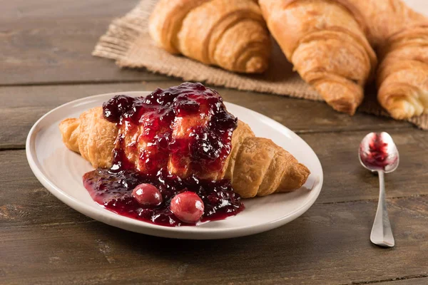 Croissant with jam on the table in natural light Stock Image