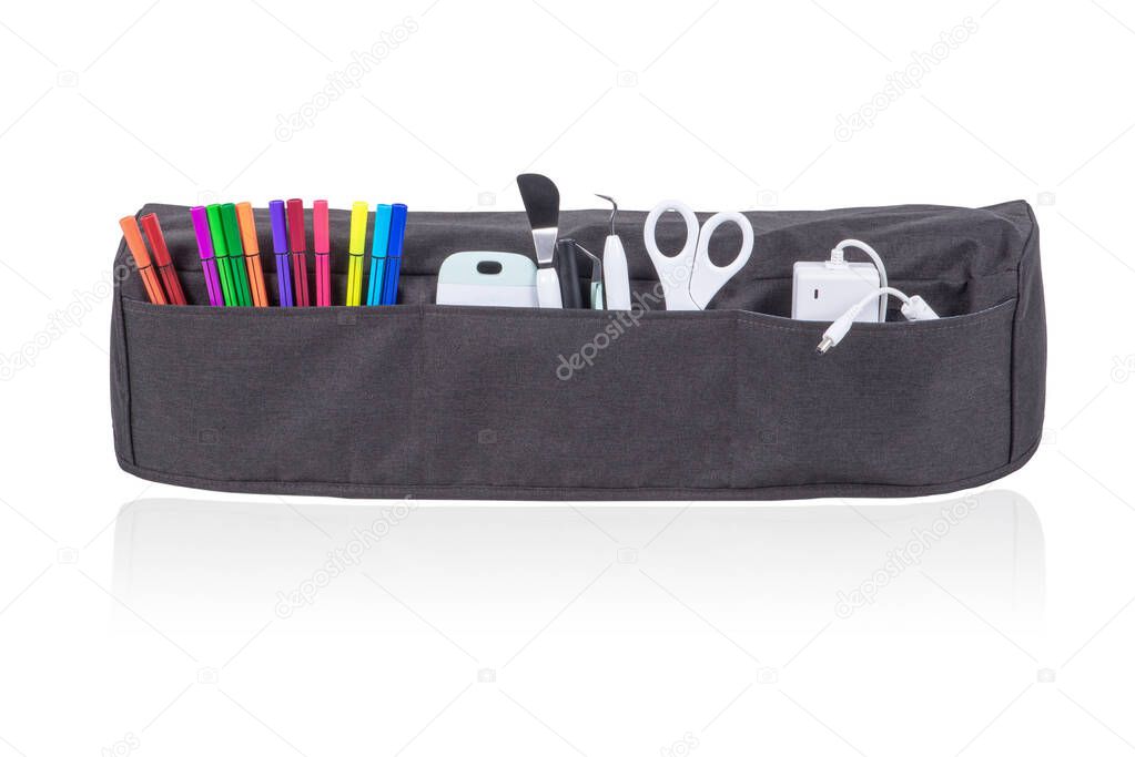 Gray cutting machine cover with all the stationery accessories isolated on white background.