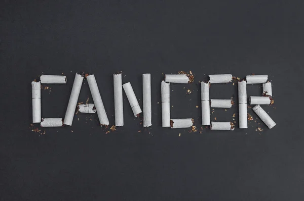 Cancer is an inscription word made from broken cigarettes