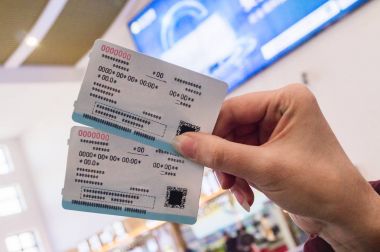 Two tickets in a woman's hand for travel by high-speed train CRH clipart