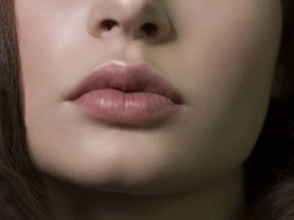 Sexual full lips. Natural gloss of lips and woman\'s skin. The mouth is closed. Increase in lips, cosmetology. Natural lips. Great summer mood with open eyes. fashion jewelry. Pink lip gloss