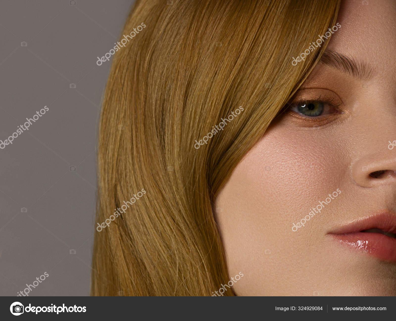 Half face beauty of a redhead with freckles and long Clear
