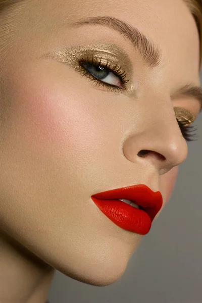 Half of a beautiful close-up of a sexy evening of a young woman make up dyed dark eyelashes and a silver liner, a beauty spa salon. Full lips with red lip gloss, clean skin and natural bare lips. — 스톡 사진