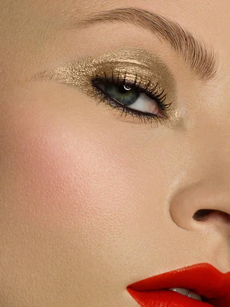 Half of a beautiful close-up of a sexy evening of a young woman make up dyed dark eyelashes and a silver liner, a beauty spa salon. Full lips with red lip gloss, clean skin and natural bare lips. — 스톡 사진