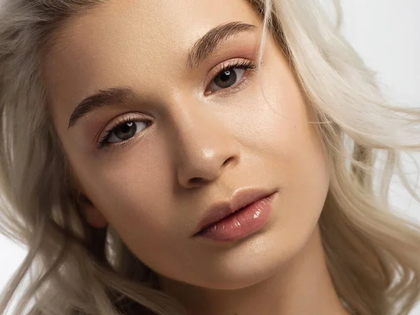 Temiz ciltli ve doğal kozmetik ürünleri olan güzel bir kadın. Güzel, ekstrem kirpik ve bakımlı bir kızın dolgun dudakları güzellik salonunda spa prosedürleri ve enjeksiyonlar gösteriyor. Sarı saç.