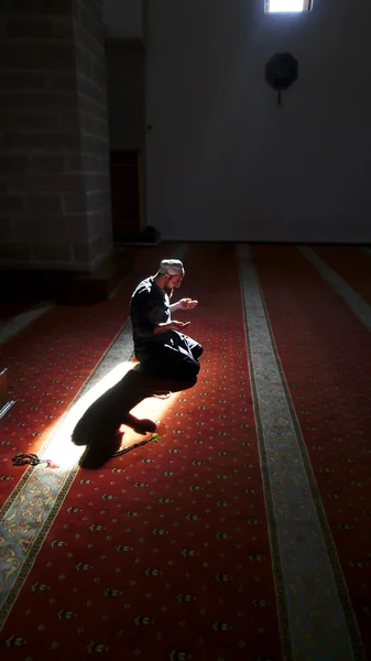 Muslims praying alone in mosque