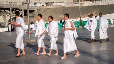 Muslim wearing ihram clothes and ready for Hajj clipart